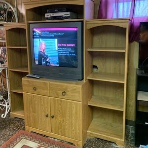 Tv stand with the tv and a vcr. All together